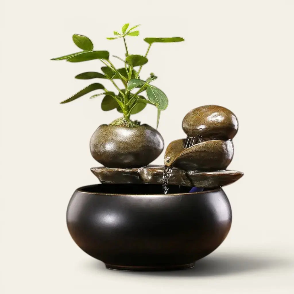 Fontaine céramique noir design avec cascade d'eau et plante verte pour une décoration zen